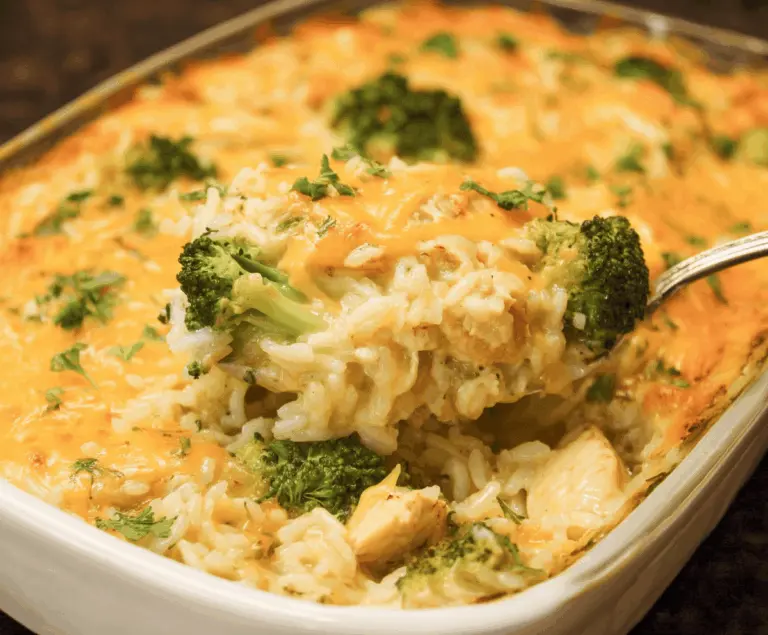 Creamy chicken broccoli rice cheese casserole in a baking dish, topped with melted cheese and fresh parsley, ready to serve.
