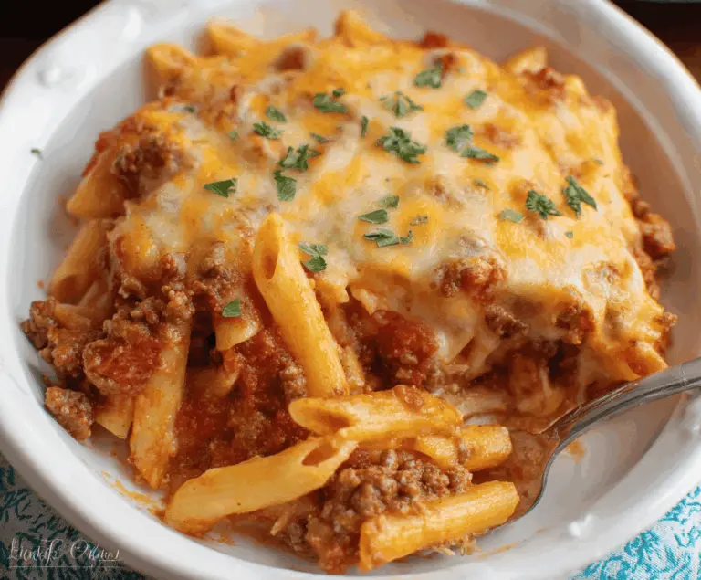 Creamy and cheesy Crock Pot Baked Ziti ready to serve, featuring pasta, melted cheese, and rich tomato sauce in a slow cooker.