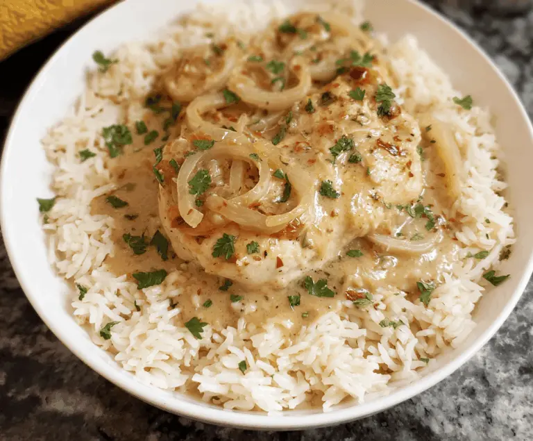 Delicious smothered chicken served over fluffy rice with savory gravy and fresh herbs
