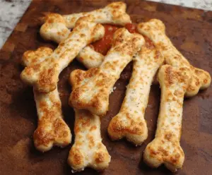 Delicious cheesy breadstick bones garnished with herbs, perfect for sharing as a savory appetizer or snack