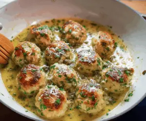 Delicious Chicken Piccata Meatballs garnished with fresh herbs and served on a plate, perfect for a flavorful Italian-inspired meal.