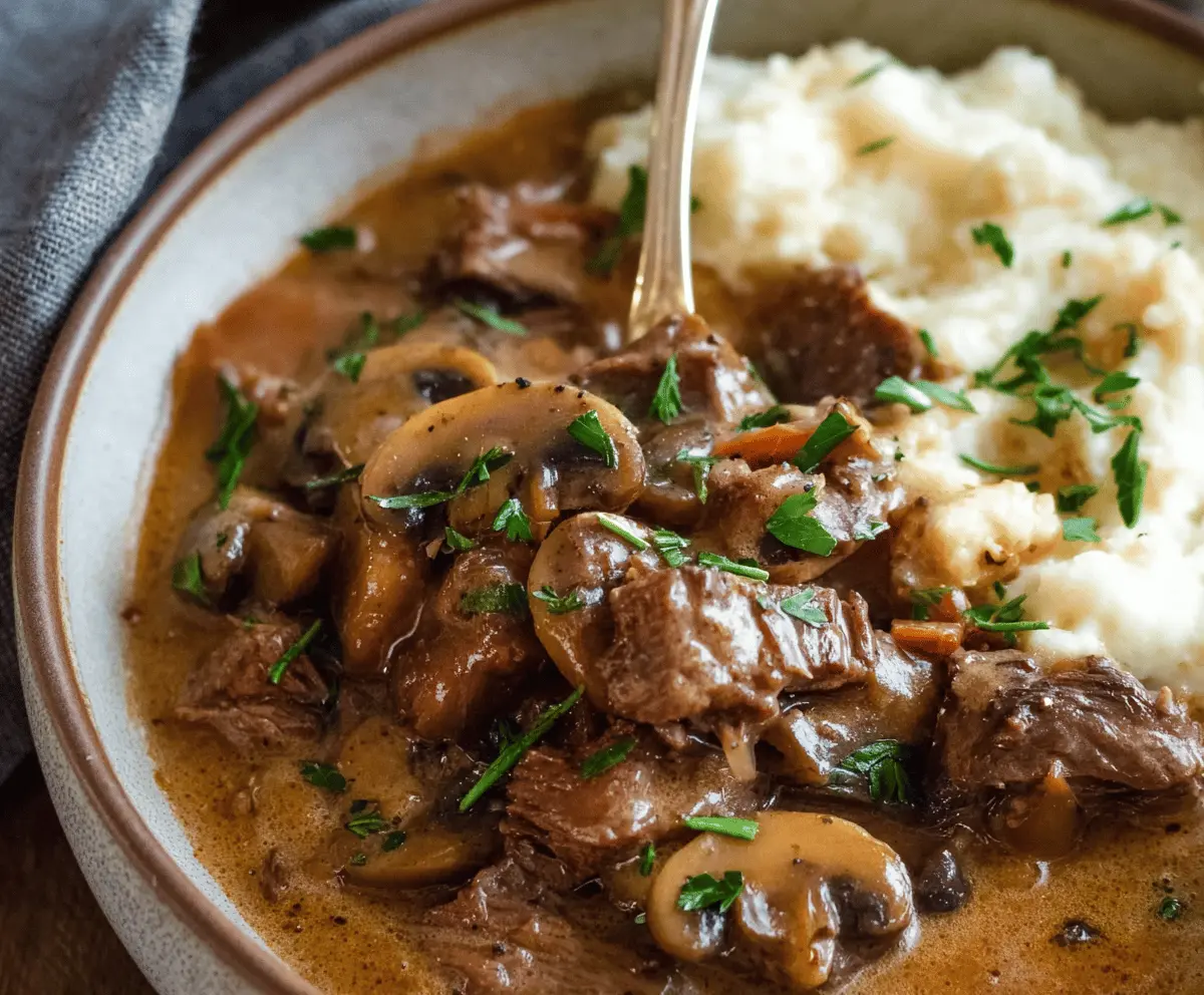 Creamy Slow Cooker Beef Stroganoff Stew with tender beef, mushrooms, and rich sauce served in a bowl