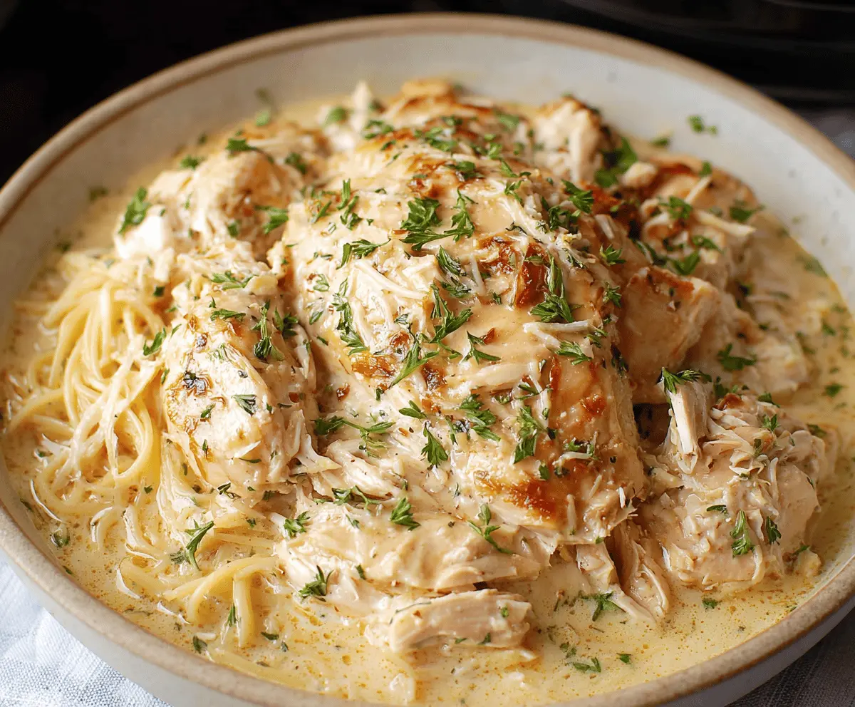 Creamy Crockpot Angel Chicken served with garlic mashed potatoes and steamed vegetables.