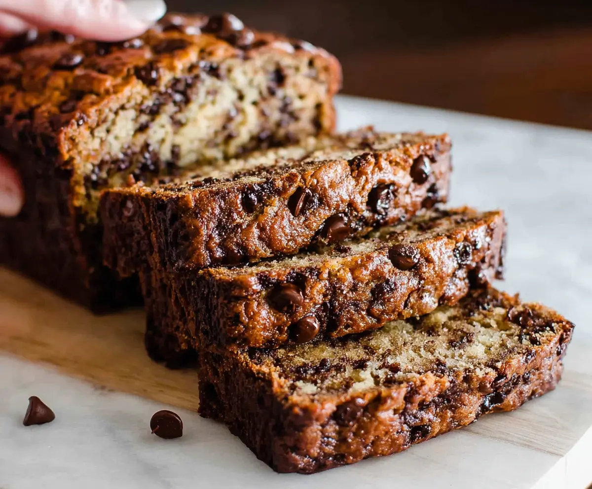 Delicious homemade chocolate chip banana bread cooling on a wire rack.