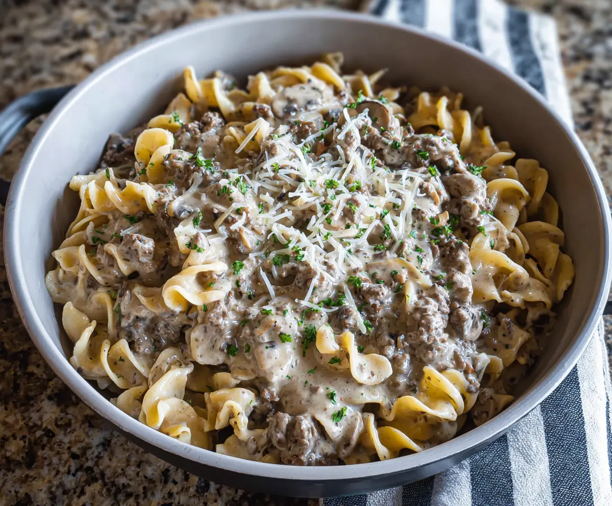 Creamy ground beef stroganoff served over noodles with mushrooms and herbs.