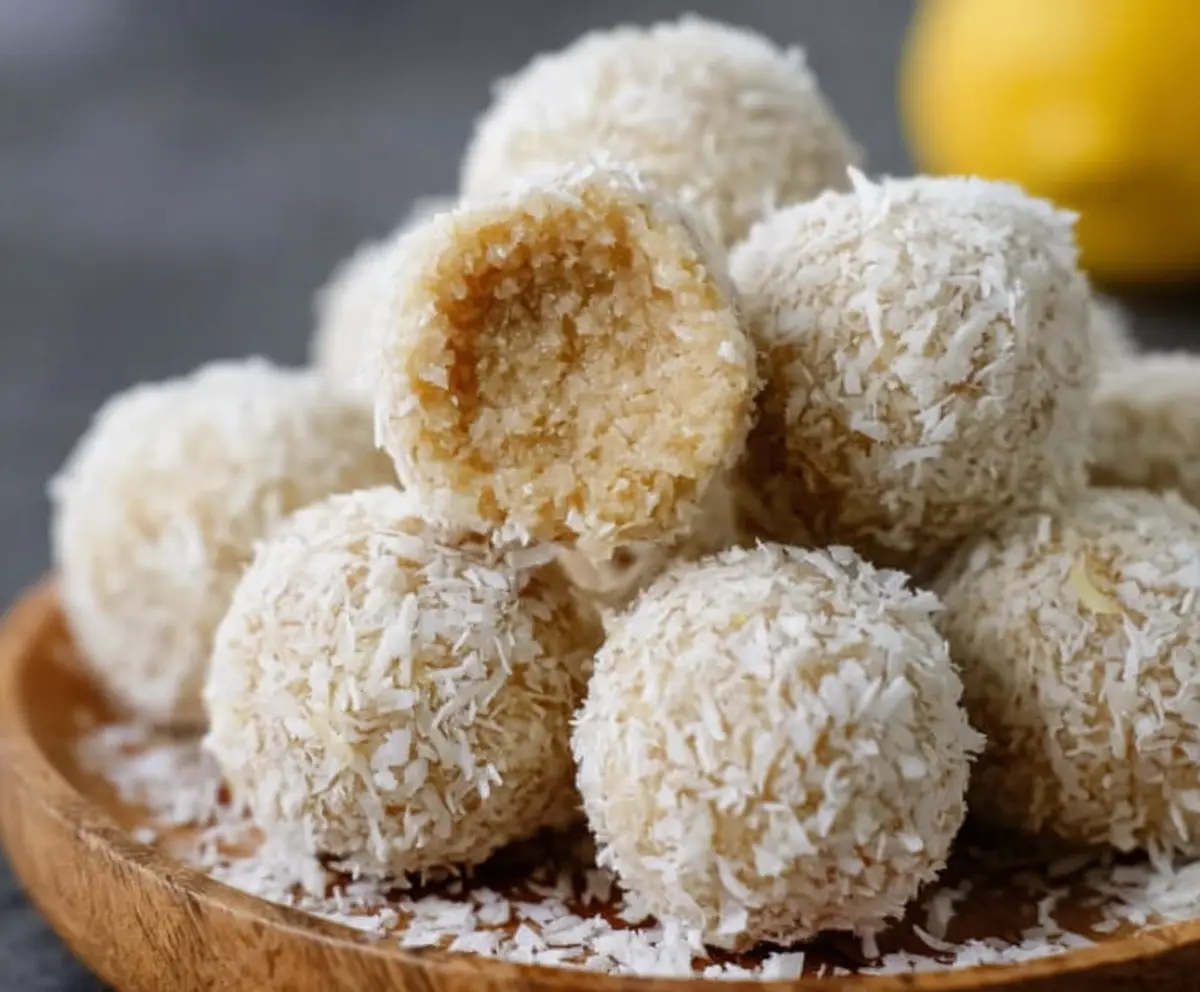 Healthy lemon coconut protein balls on a white plate, perfect for a nutritious snack.