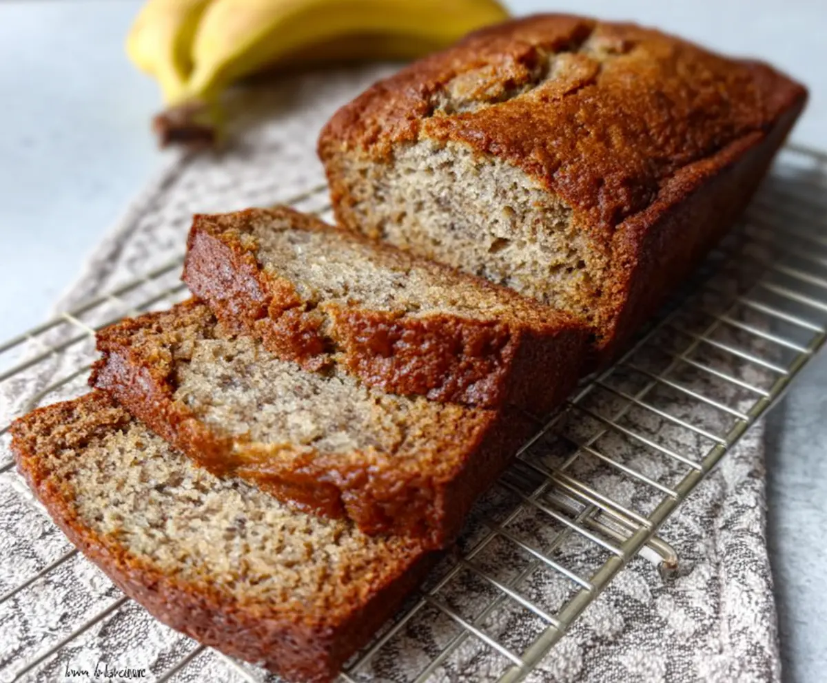 Delicious ultra-moist classic banana bread fresh from the oven with ripe bananas and golden crust