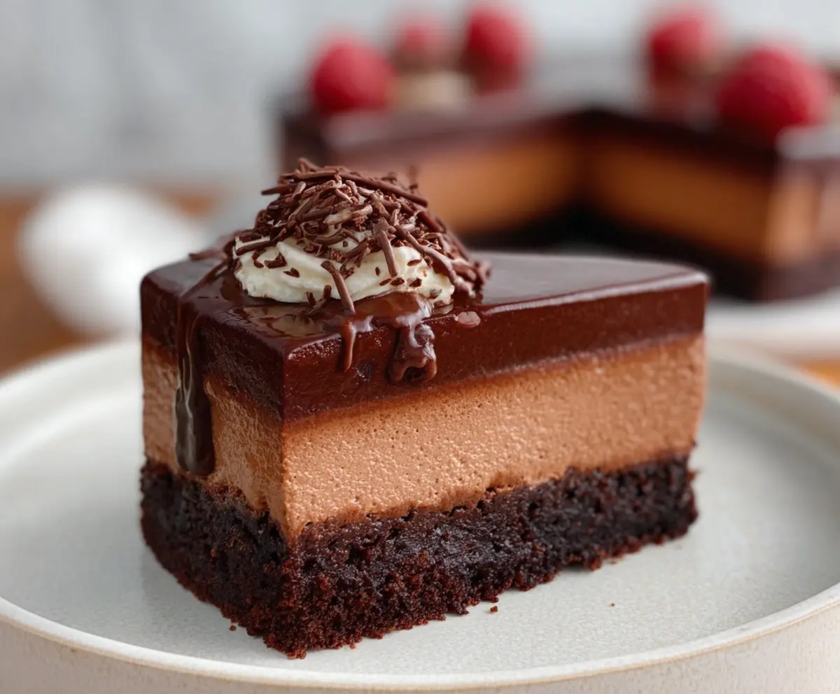 Delicious chocolate mousse-filled brownies with a rich, glossy chocolate topping