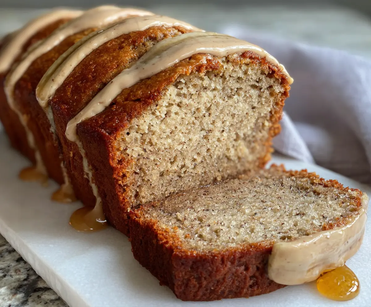 Delicious honey vanilla banana bread fresh out of the oven with a golden crust and ripe bananas.