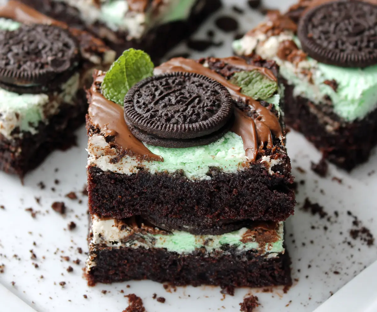 Rich, fudgy triple layer mint Oreo brownies with a glossy chocolate topping.