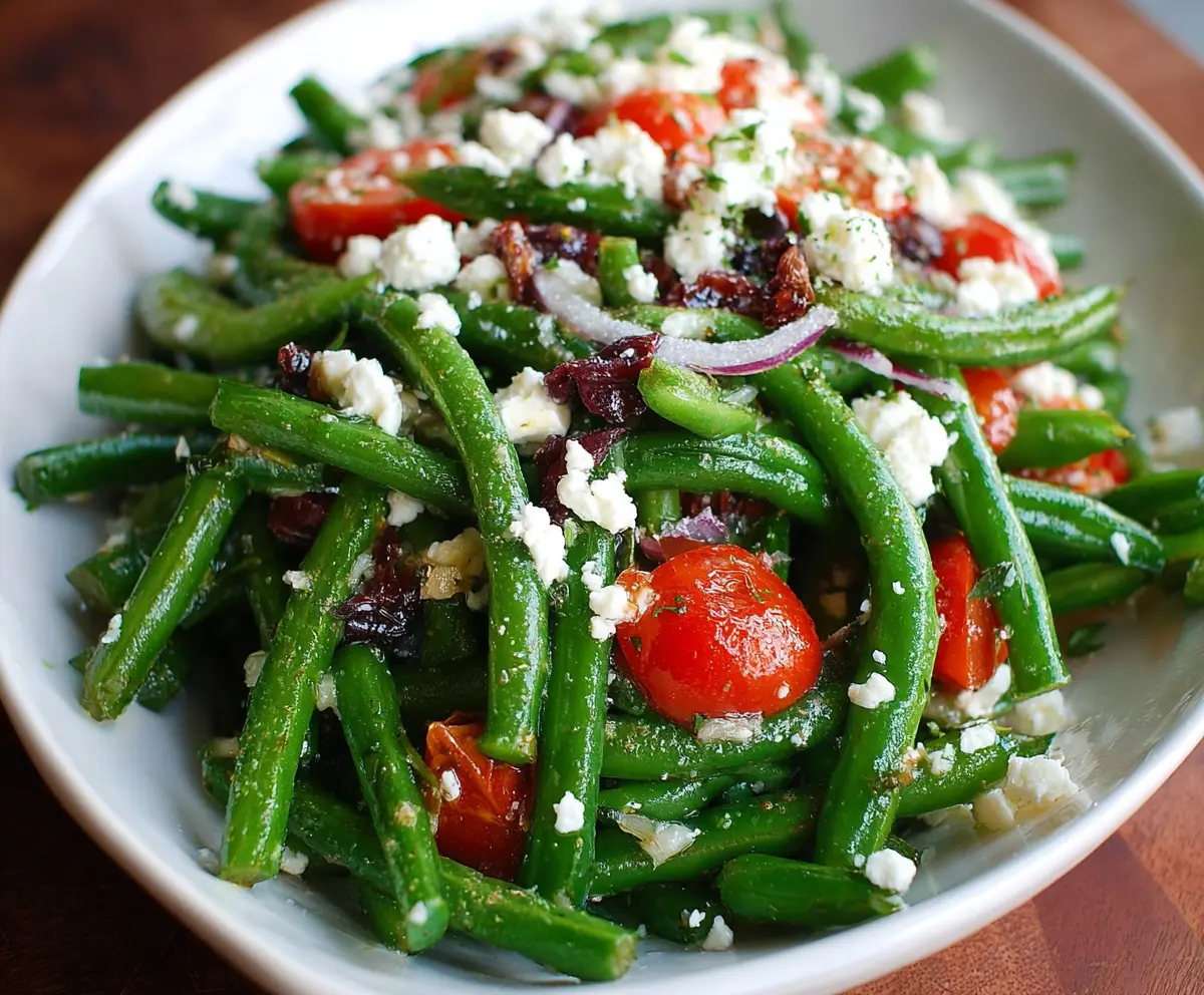 Fresh green bean and feta cheese salad topped with herbs, perfect for a healthy appetizer or side dish.