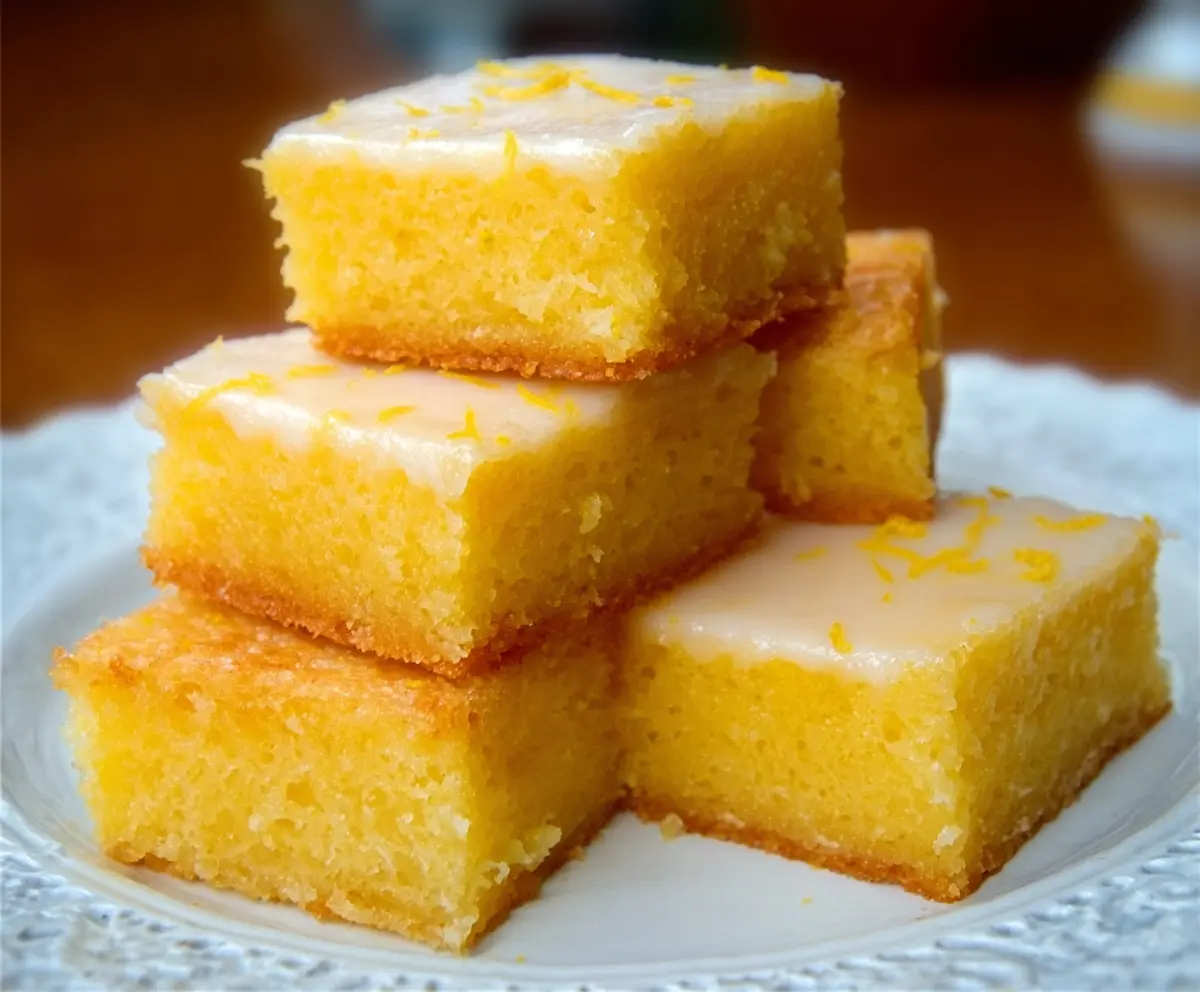 Delicious homemade lemon brownies with a zesty lemon glaze on top, perfect for a sweet citrus treat.